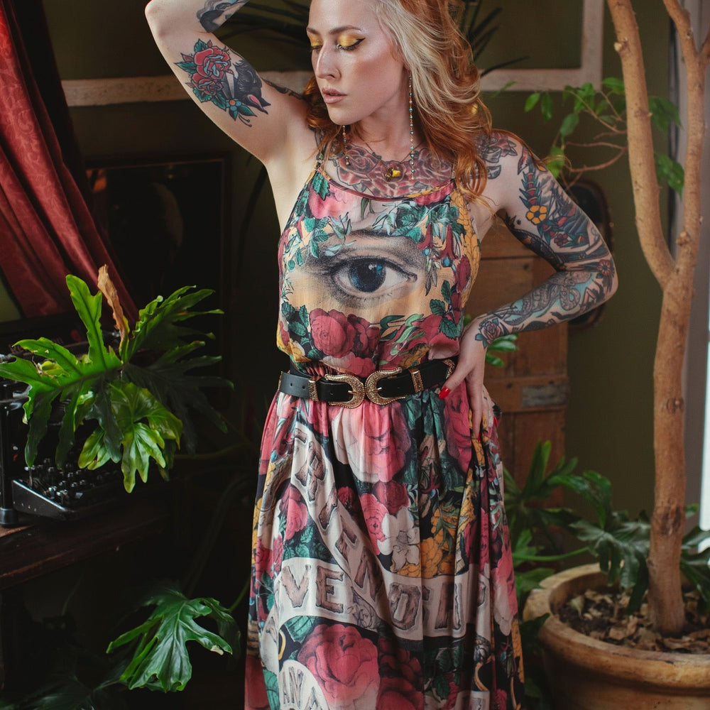 
                  
                    Model wearing reversible bamboo viscose slip dress featuring vintage symbols of friendship, love, and truth with pink and rose palette – Market of Stars.
                  
                