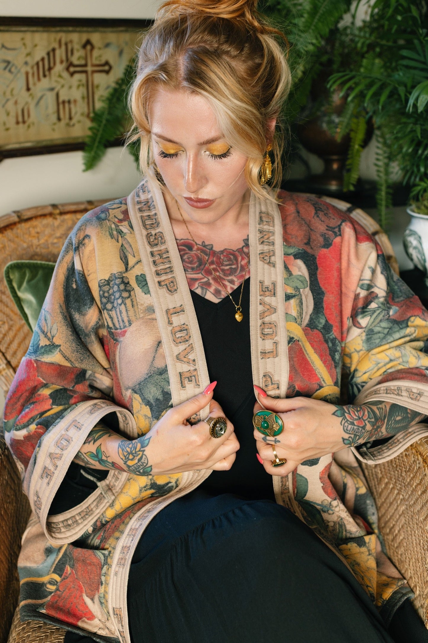 Model wearing cozy printed cardigan with vintage symbols of love, truth, and friendship, featuring charming wood-grain trim and patch pockets – Market of Stars.