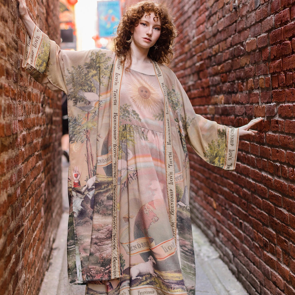 Model wearing sun-washed vintage-inspired Opera Duster featuring symbols of friendship, love, and truth in soft lavender, sage, gold, and aqua – Market of Stars