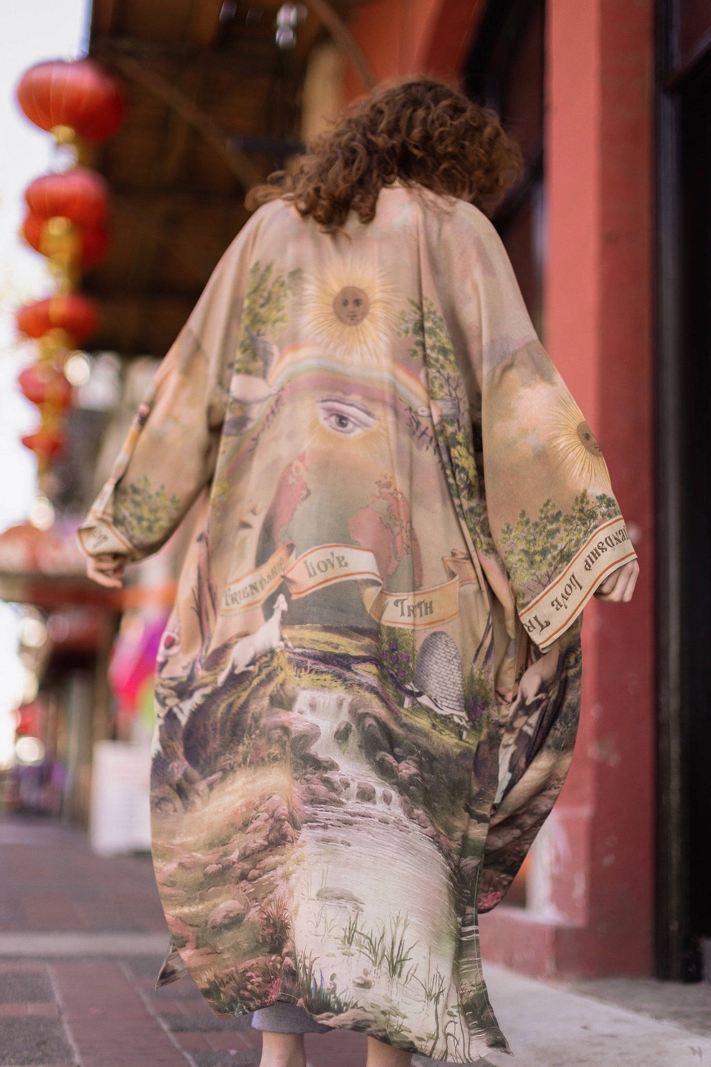 Model wearing sun-washed vintage-inspired Opera Duster featuring symbols of friendship, love, and truth in soft lavender, sage, gold, and aqua – Market of Stars