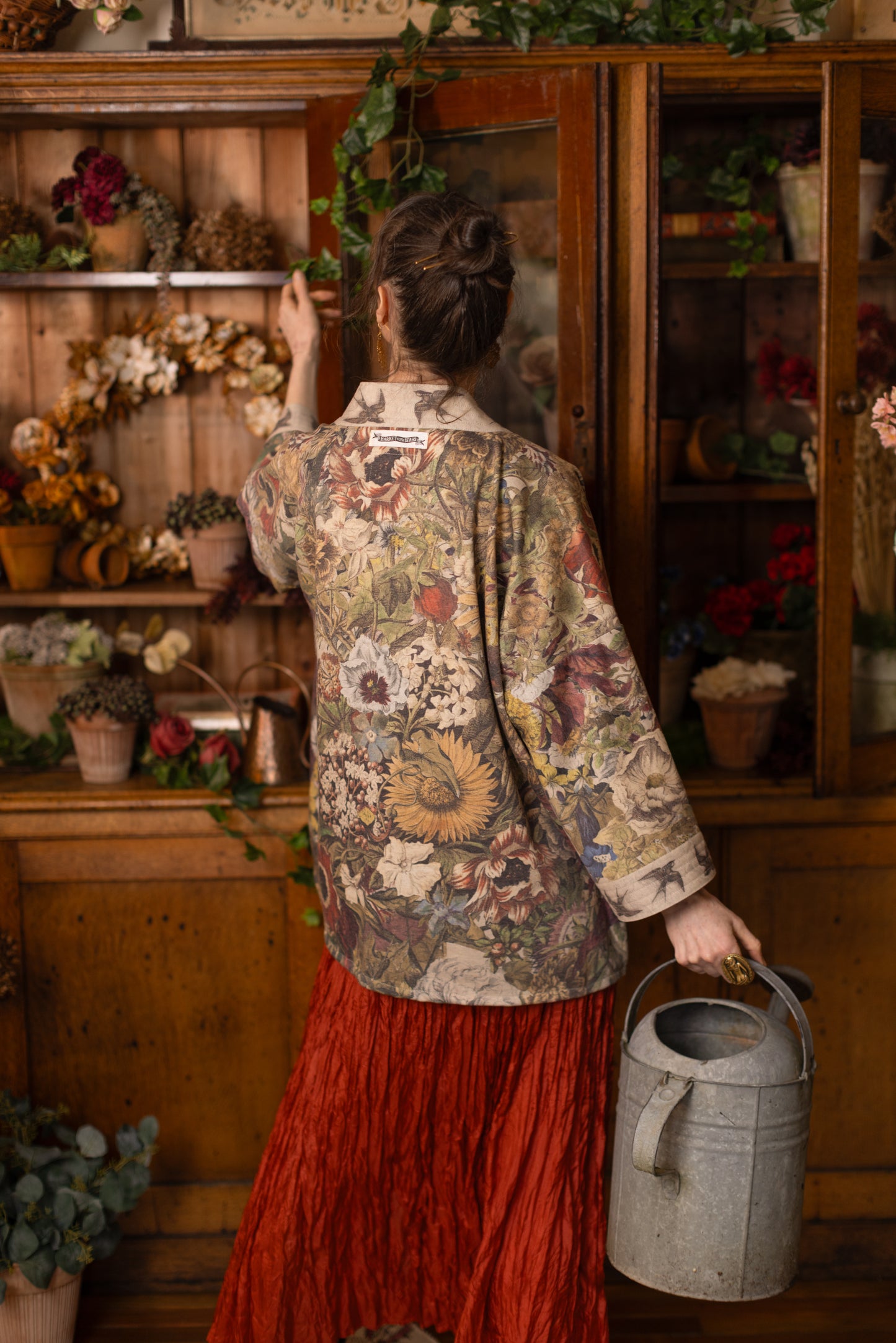 Model wearing a soft fleece cottage cardigan featuring rich 1700s botanical blooms and swallow trim - Market of Stars