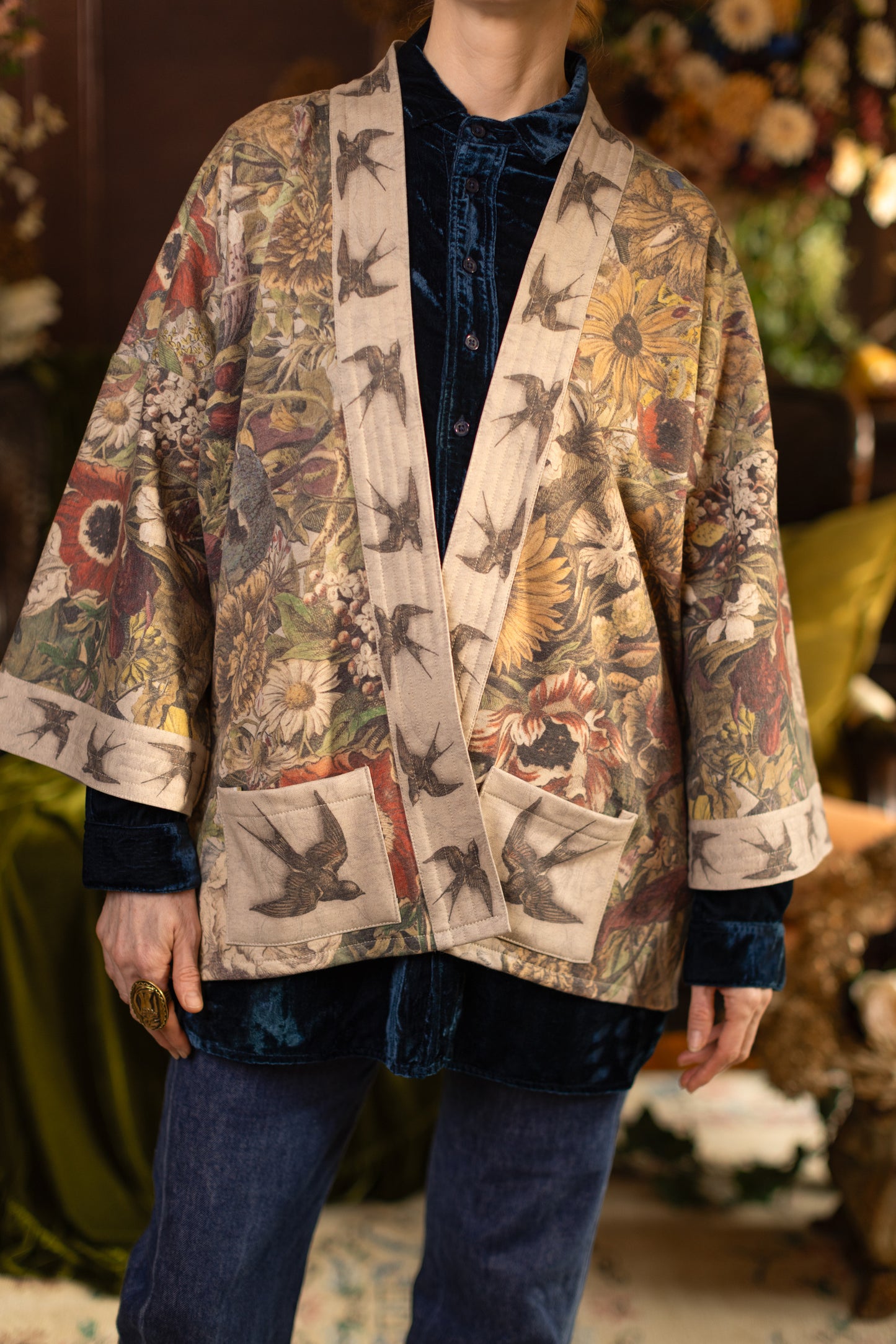 Model wearing a soft fleece cottage cardigan featuring rich 1700s botanical blooms and swallow trim - Market of Stars