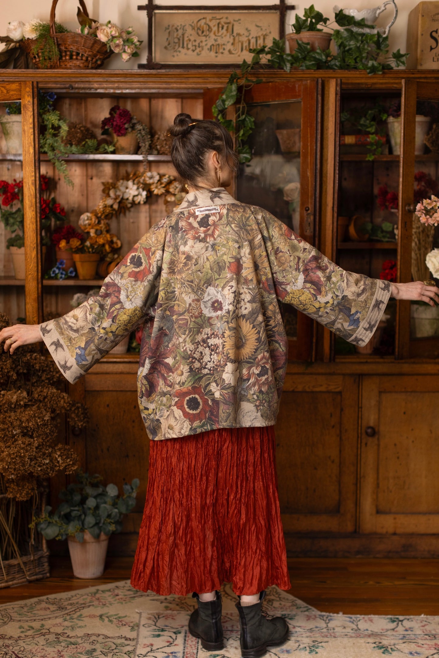 Model wearing a soft fleece cottage cardigan featuring rich 1700s botanical blooms and swallow trim - Market of Stars