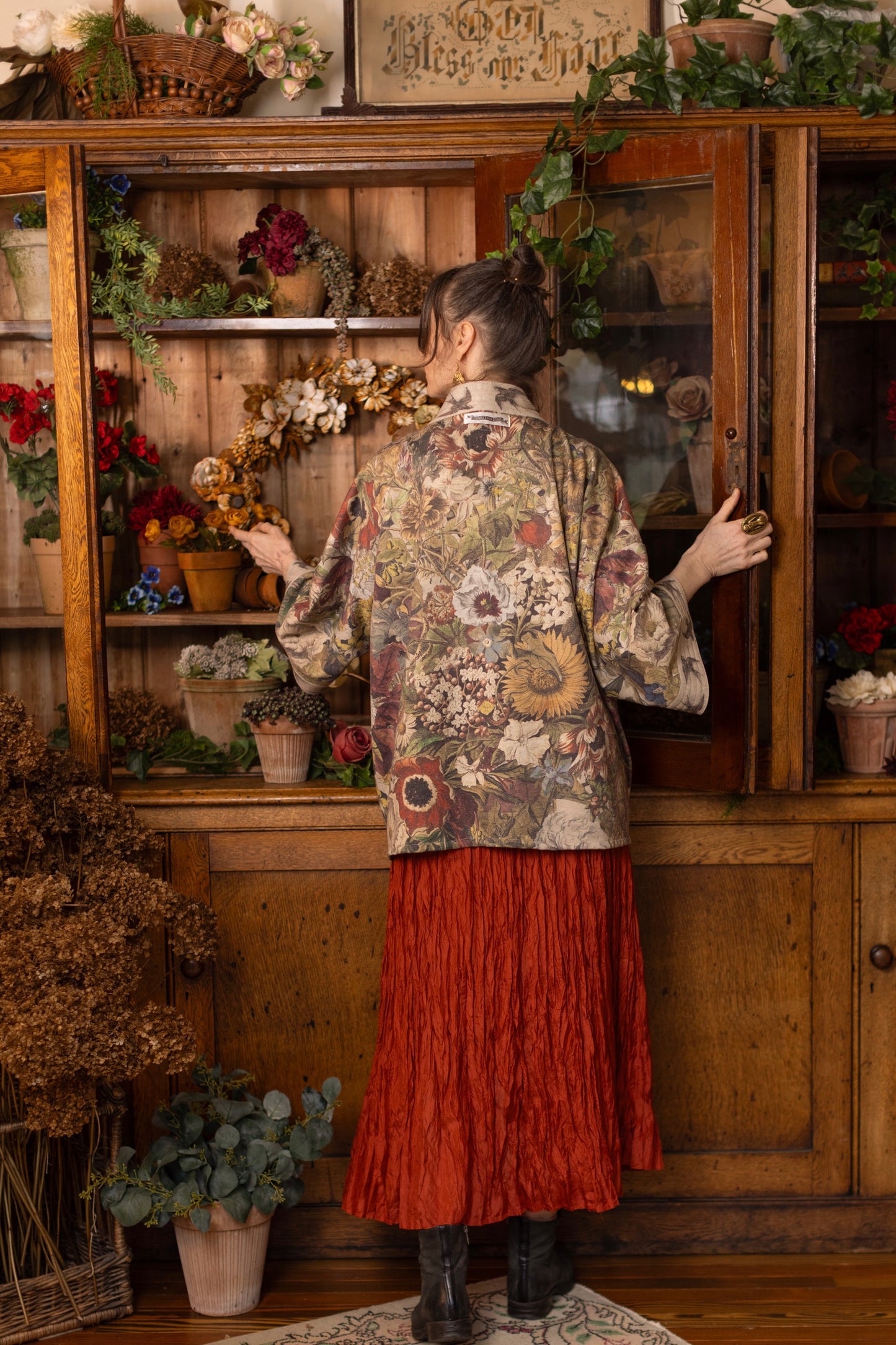 Model wearing a soft fleece cottage cardigan featuring rich 1700s botanical blooms and swallow trim - Market of Stars