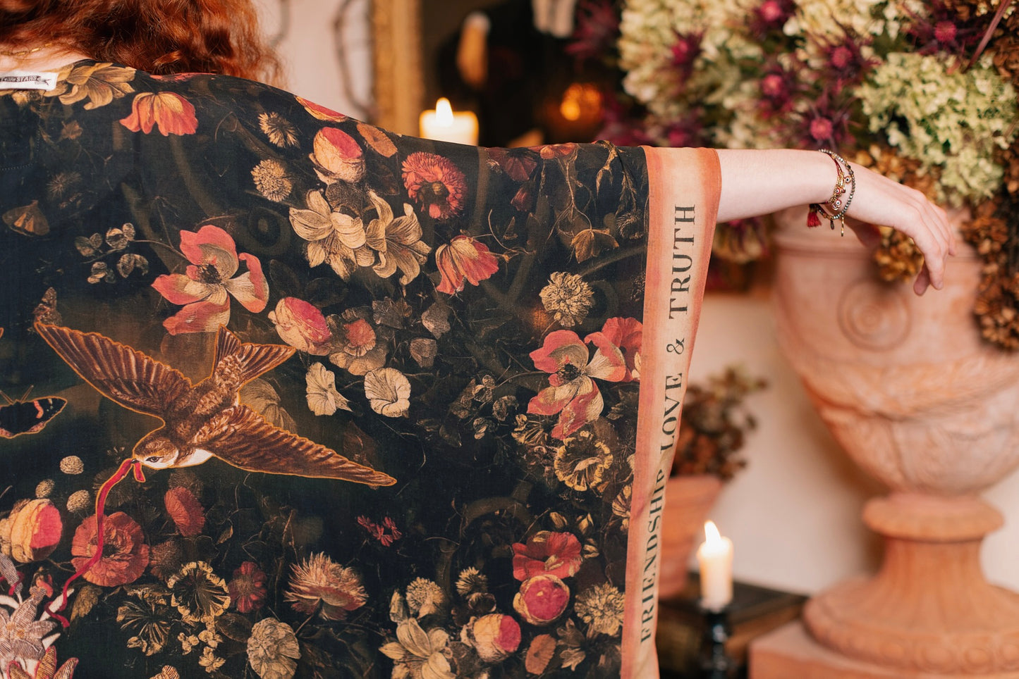 Model wearing a flowy bamboo-viscose duster featuring a collage of antique artwork with romance, loyalty, and old-world beauty - Market of Stars