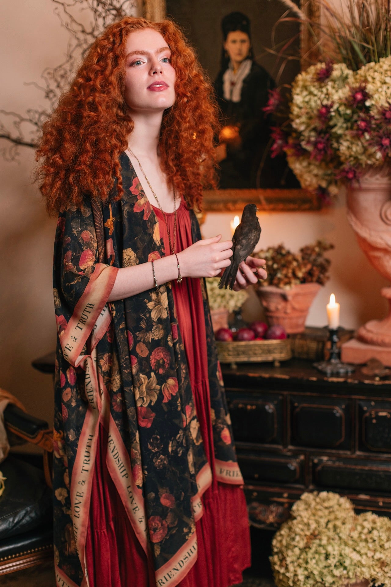 Model wearing a flowy bamboo-viscose duster featuring a collage of antique artwork with romance, loyalty, and old-world beauty - Market of Stars