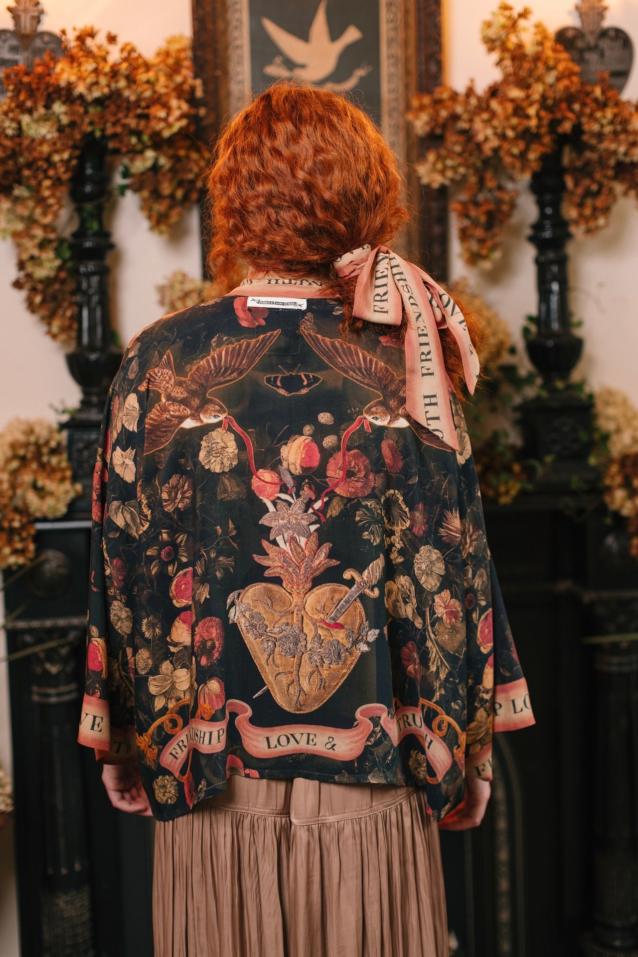 Model wearing a cropped-length bamboo-viscose duster featuring a collage of antique artwork with romance, loyalty, and old-world beauty - Market of Stars