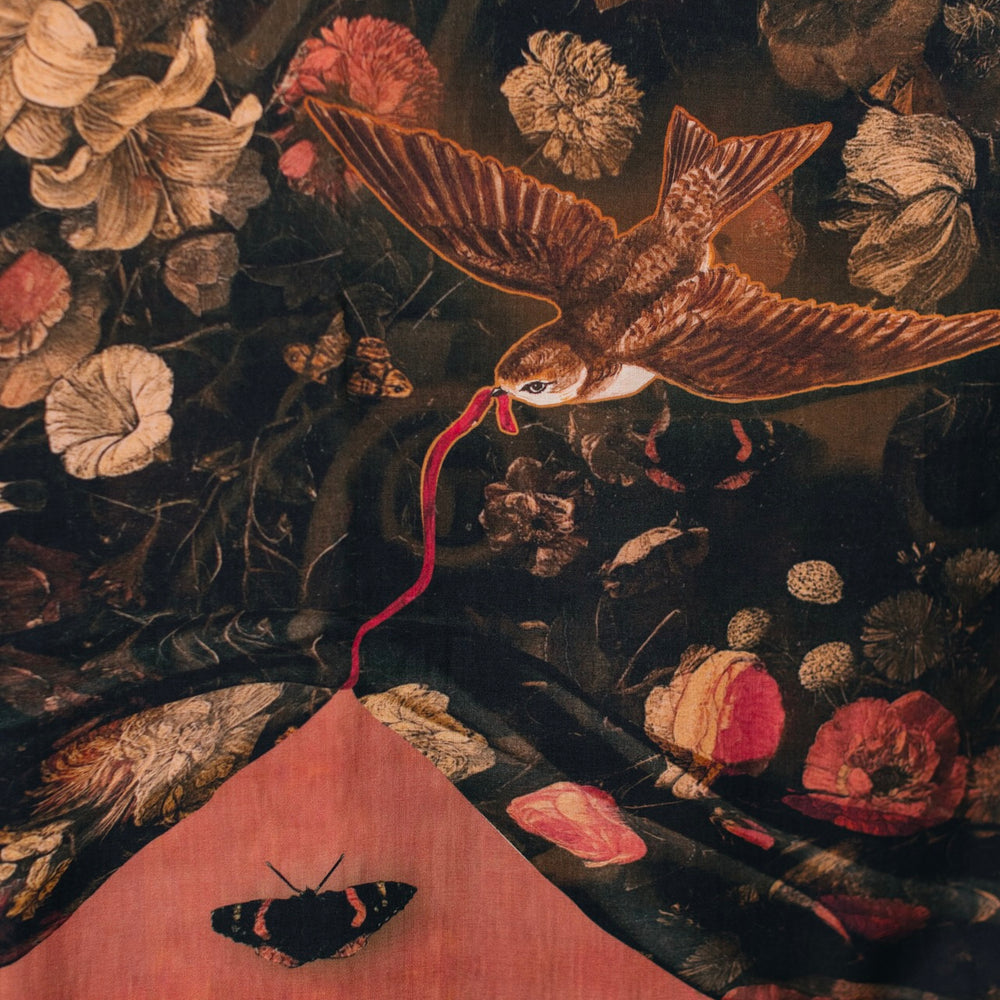 
                  
                    Model wearing a maxi-length bamboo-viscose slip dress featuring a collage of antique artwork with romance, loyalty, and old-world beauty - Market of Stars
                  
                