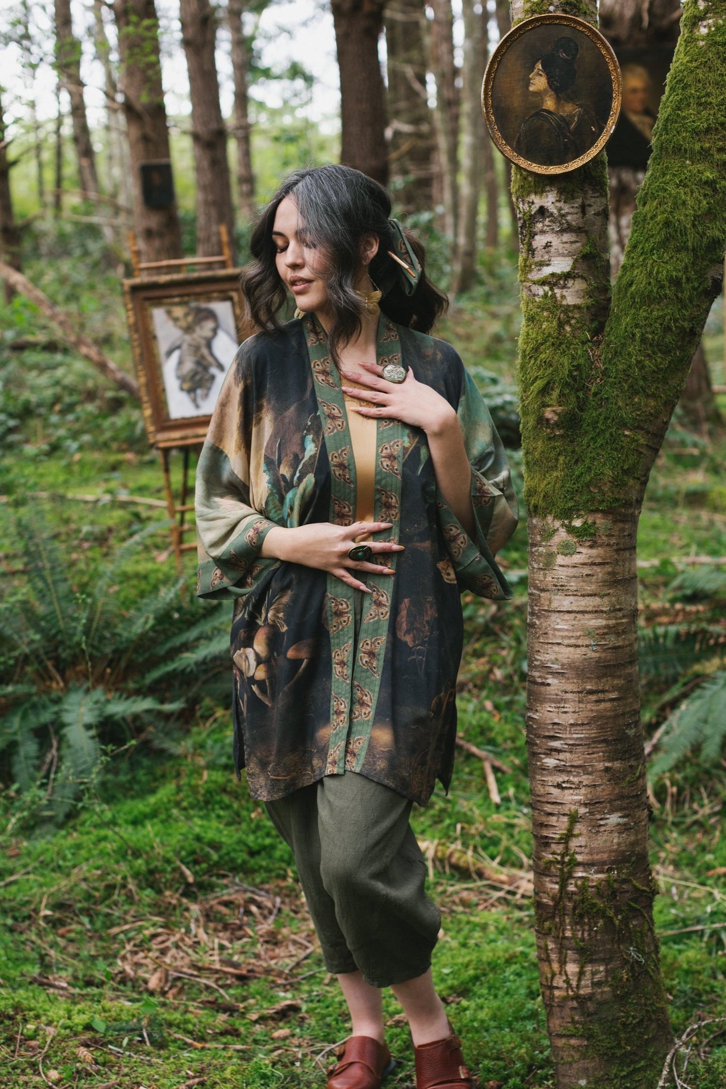 Model wearing the Heartwork Cropped Kimono featuring Artemisia Gentileschi’s self-portrait with lush forest, birds, and butterflies – Market of Stars.