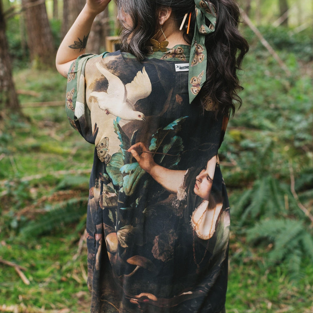 Model wearing the Heartwork Cropped Kimono featuring Artemisia Gentileschi’s self-portrait with lush forest, birds, and butterflies – Market of Stars.