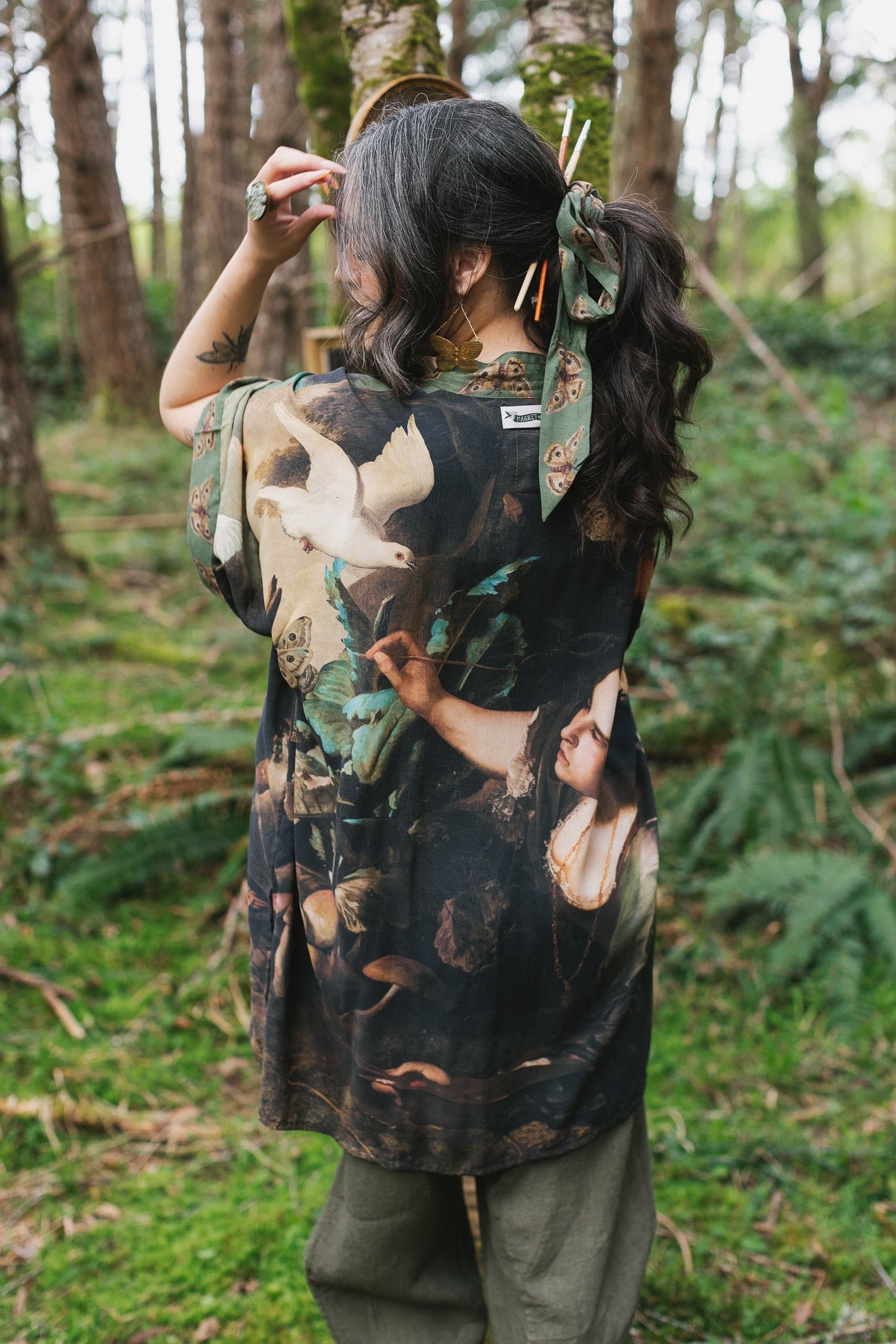 Model wearing the Heartwork Cropped Kimono featuring Artemisia Gentileschi’s self-portrait with lush forest, birds, and butterflies – Market of Stars.