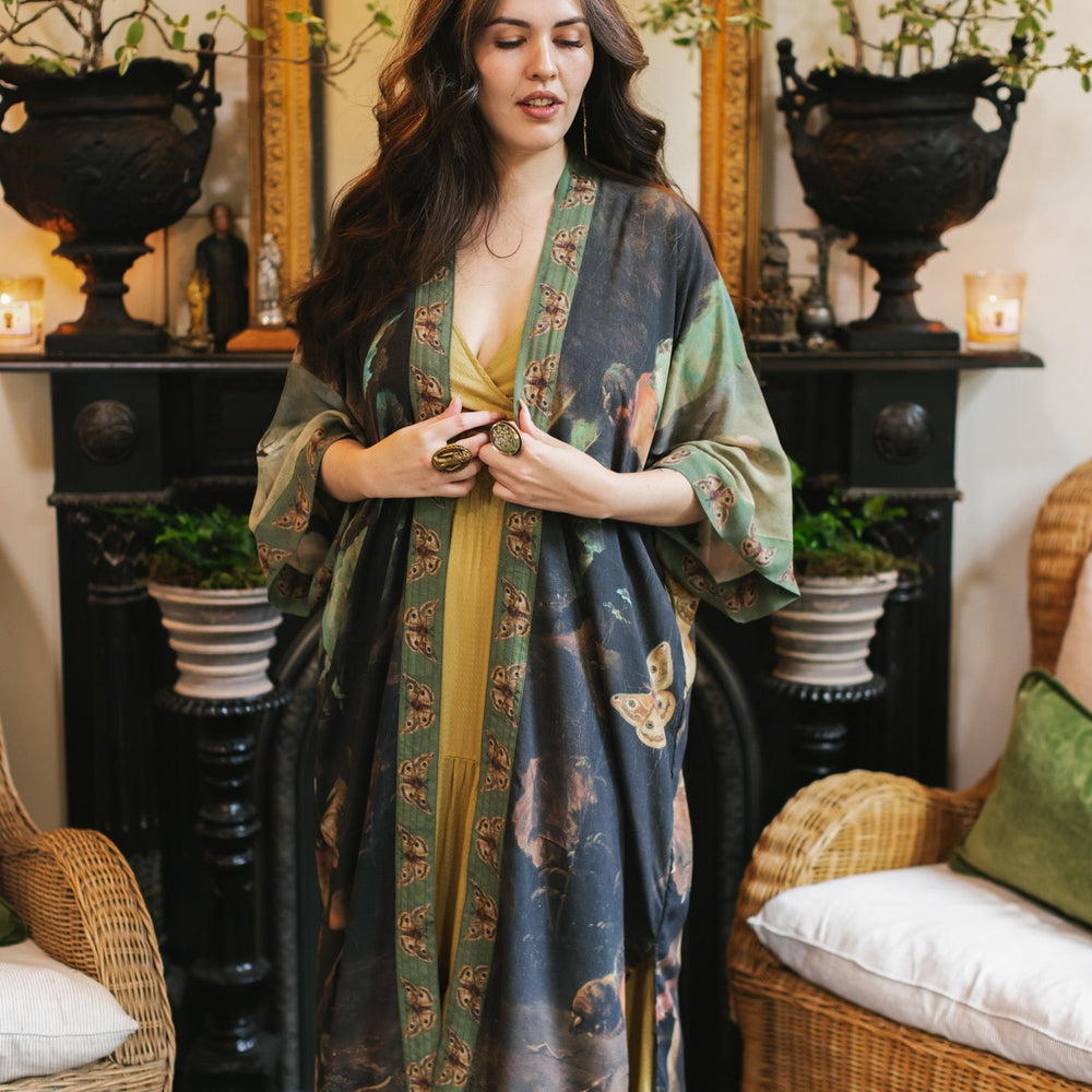 Model wearing the Heartwork Opera Duster featuring Artemisia Gentileschi’s self-portrait surrounded by forest, birds, and butterflies – Market of Stars.