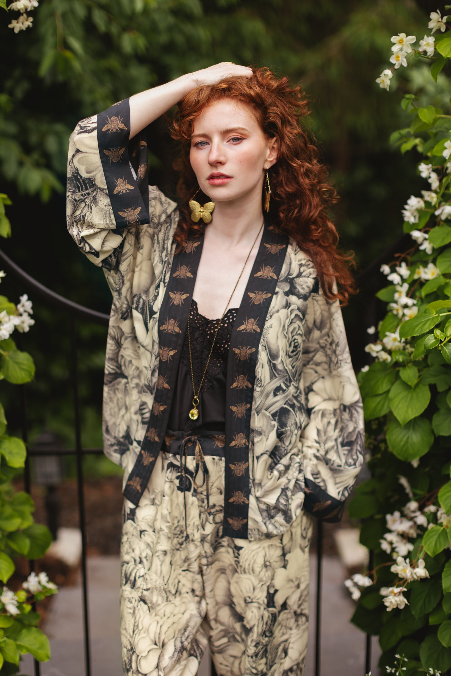 Model wearing a cropped length duster featuring black-and-ivory floral lithographs from the 1900's - Market of Stars