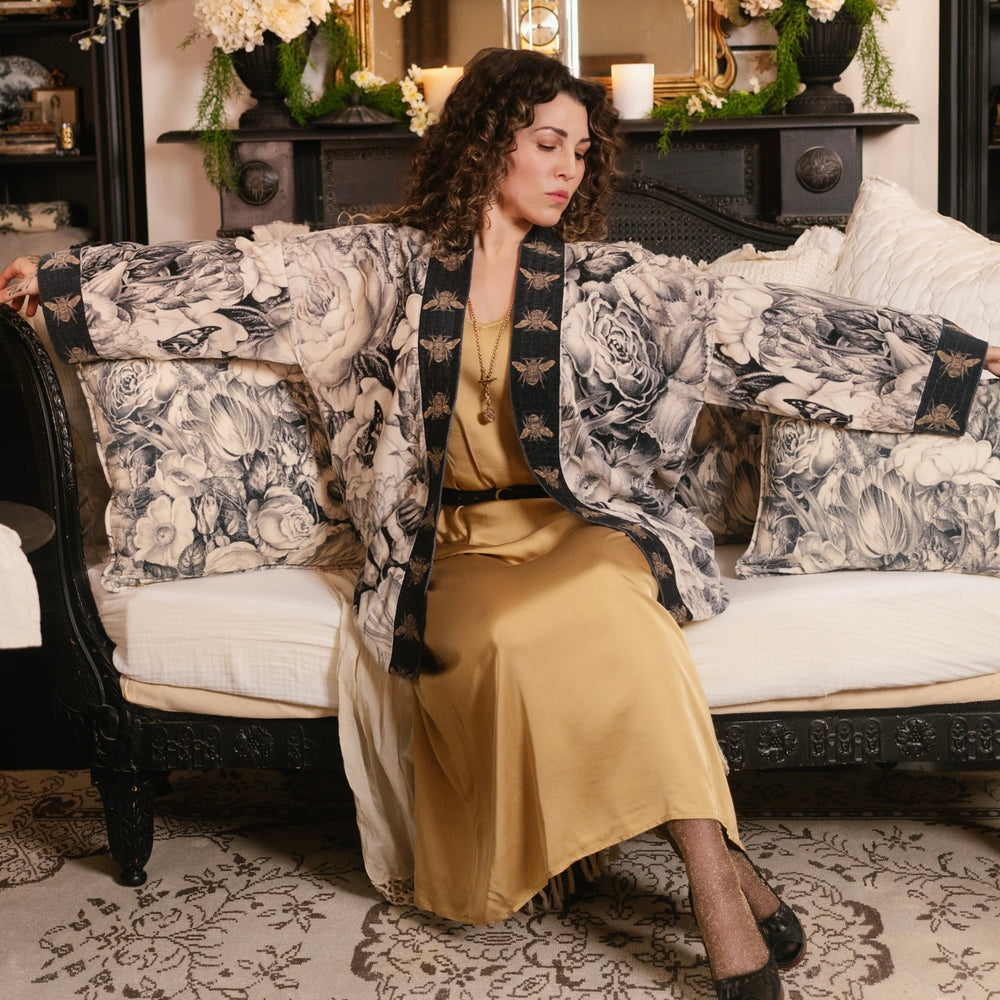 
                  
                    Model wearing a soft cotton velvet duster ft. 1900's floral lithographs. A garden dreamt up in ink - Market of Stars
                  
                