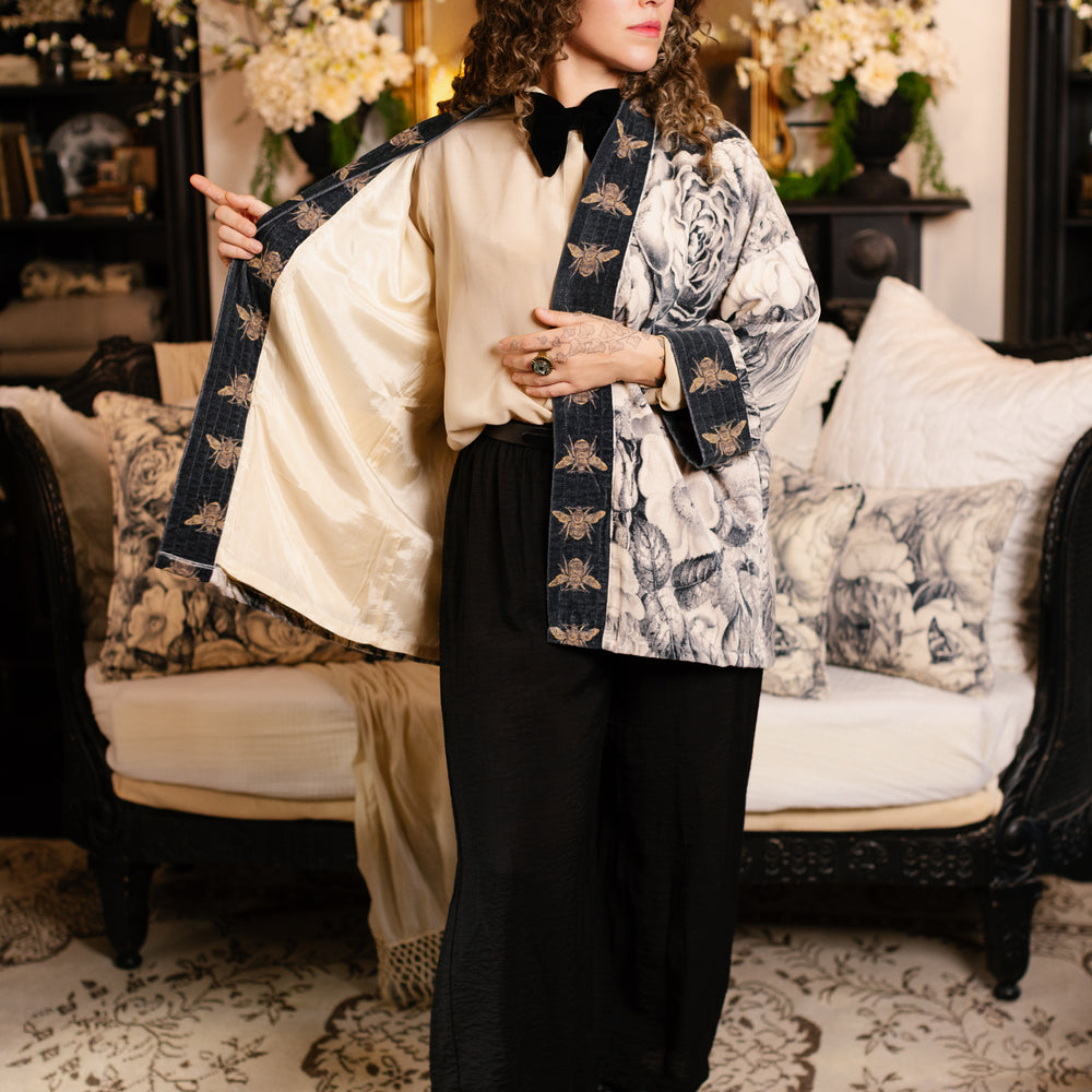 
                  
                    Model wearing a soft cotton velvet duster ft. 1900's floral lithographs. A garden dreamt up in ink - Market of Stars
                  
                