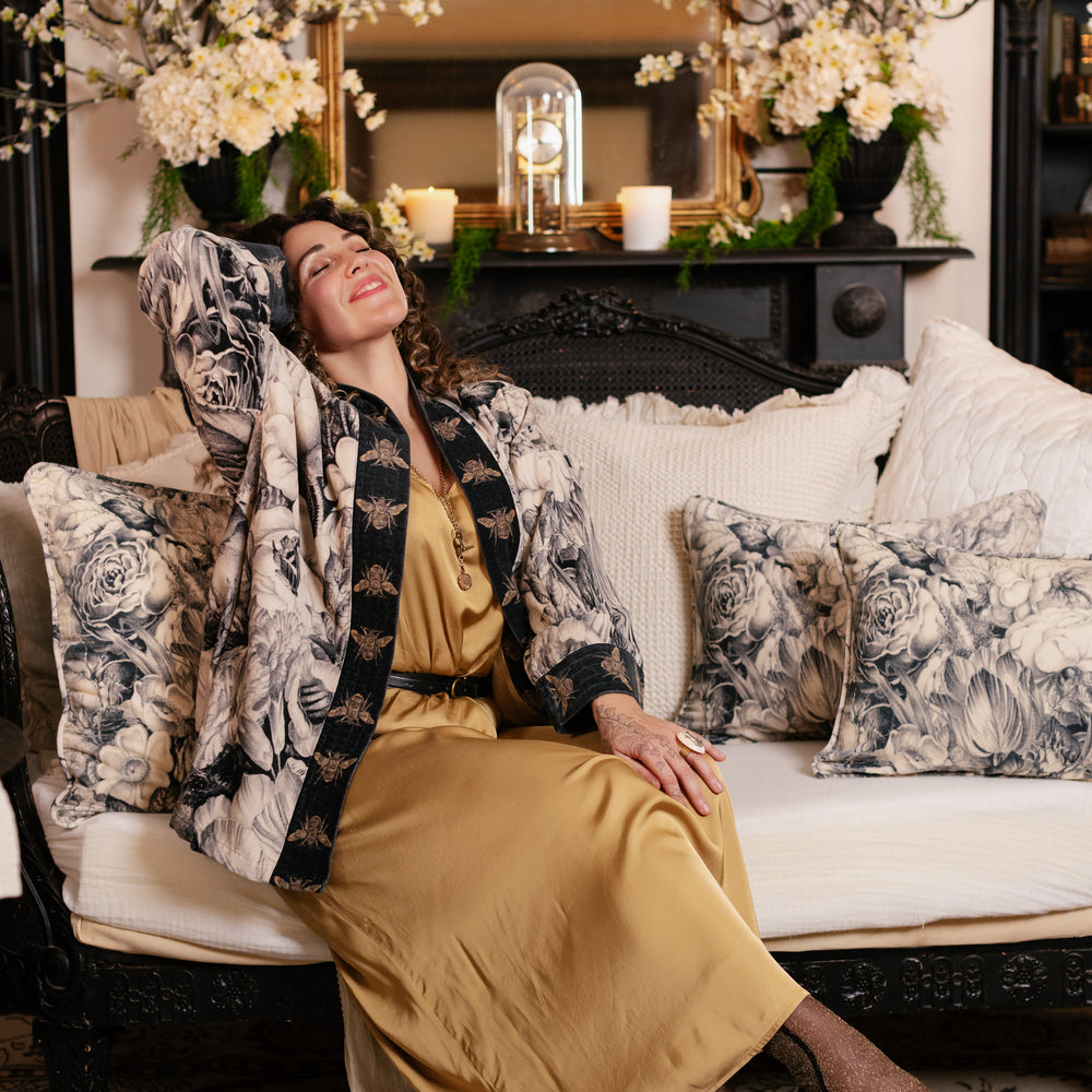 
                  
                    Model wearing a soft cotton velvet duster ft. 1900's floral lithographs. A garden dreamt up in ink - Market of Stars
                  
                