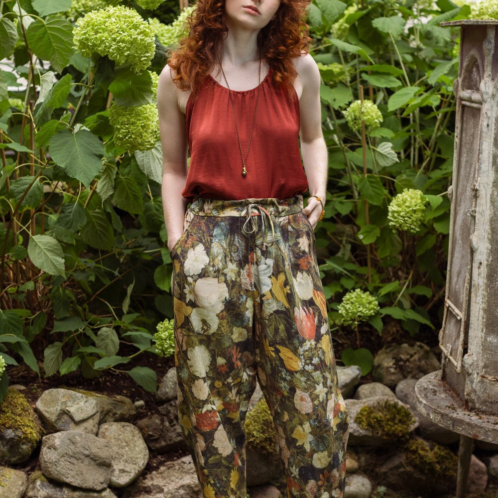 Model wearing the I Dream in Flowers Artist Pants featuring romantic floral artwork by Jan Brueghel and Victorian bumblebee trim, styled for everyday ease – Market of Stars