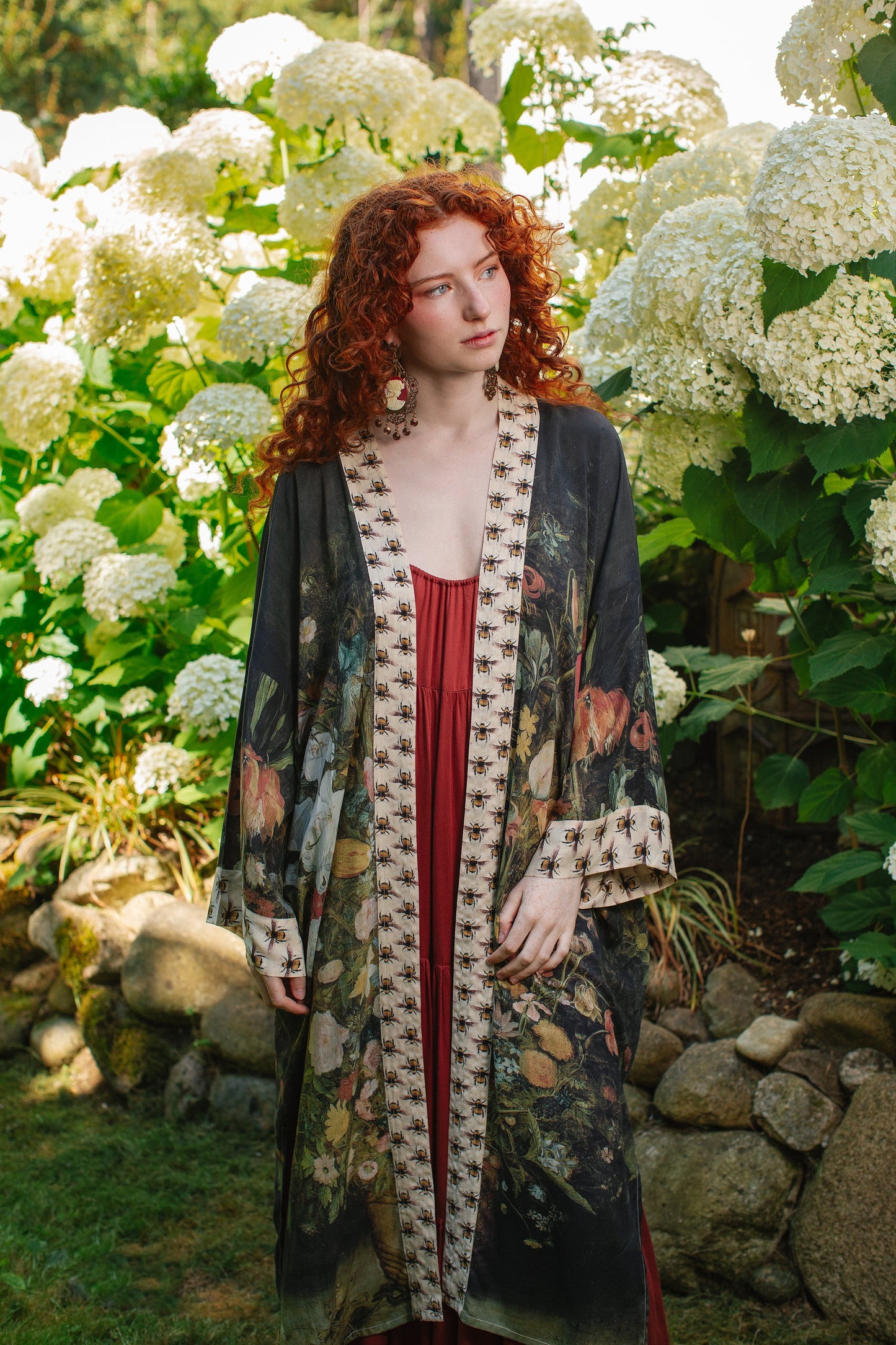 Model wearing the I Dream in Flowers Opera Duster featuring floral oil painting by Jan Brueghel and Victorian bumblebee trim – Market of Stars.
