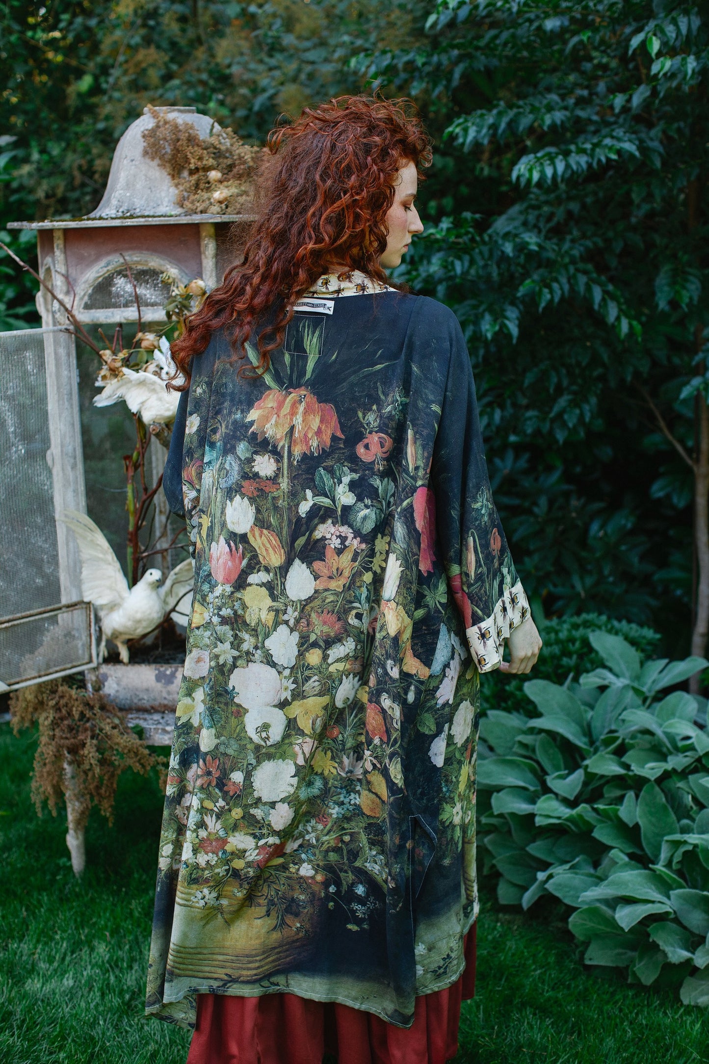 Model wearing the I Dream in Flowers Opera Duster featuring floral oil painting by Jan Brueghel and Victorian bumblebee trim – Market of Stars.