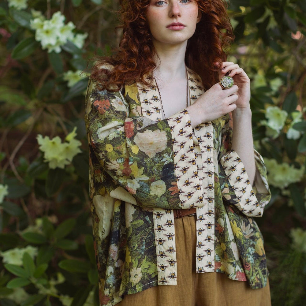 Model wearing the I Dream in Flowers cropped kimono featuring romantic floral artwork by Jan Brueghel and Victorian bumblebee trim – Market of Stars.