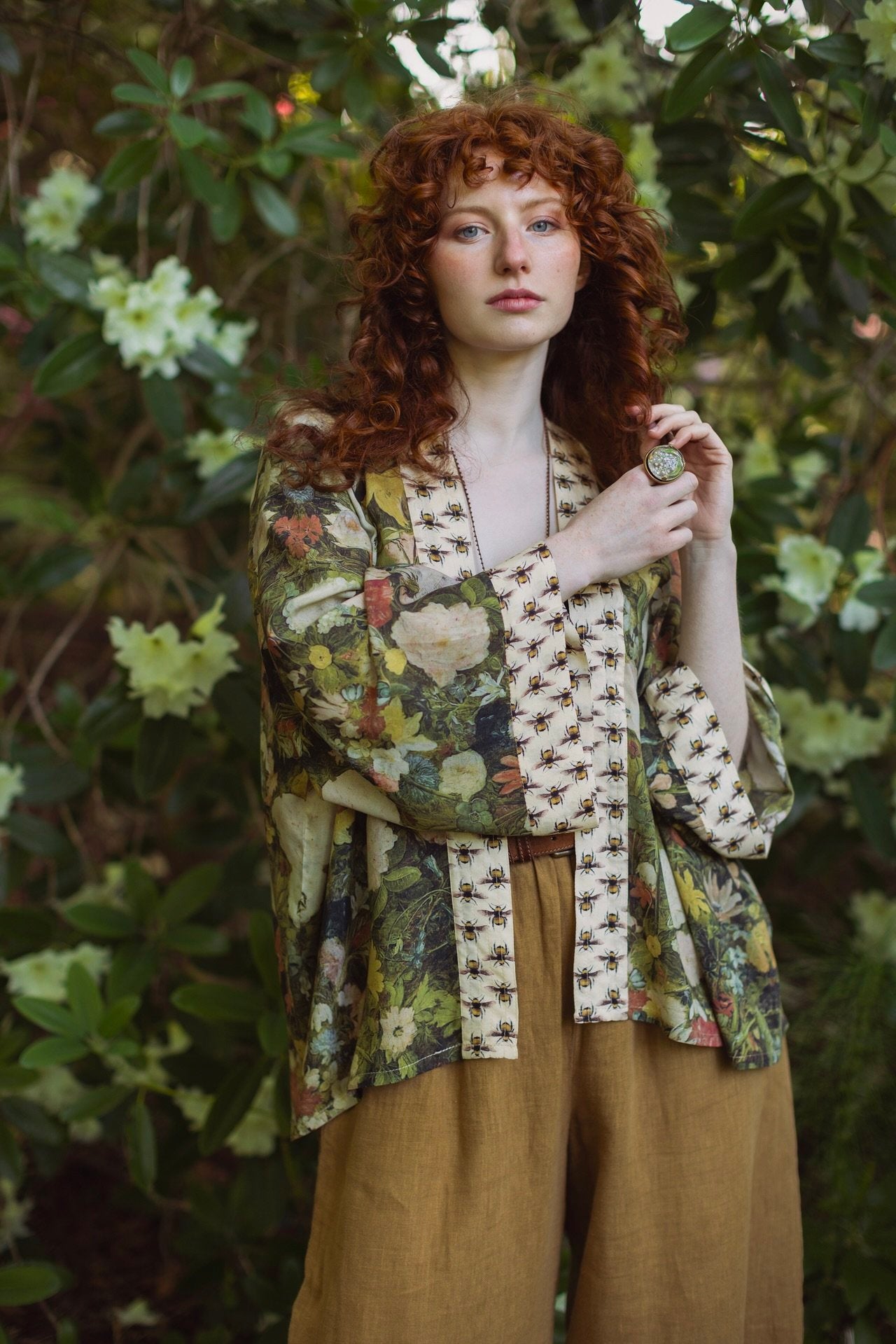Model wearing the I Dream in Flowers cropped kimono featuring romantic floral artwork by Jan Brueghel and Victorian bumblebee trim – Market of Stars.