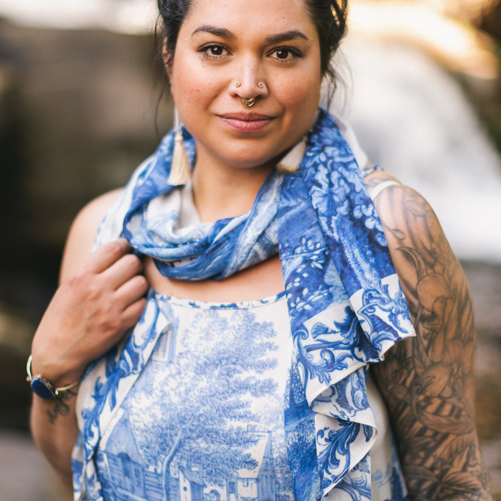 
                  
                    Let the Light In airy bamboo viscose scarf featuring print of Delft blue and white pottery, and positive message of light and hope - Market of Stars
                  
                
