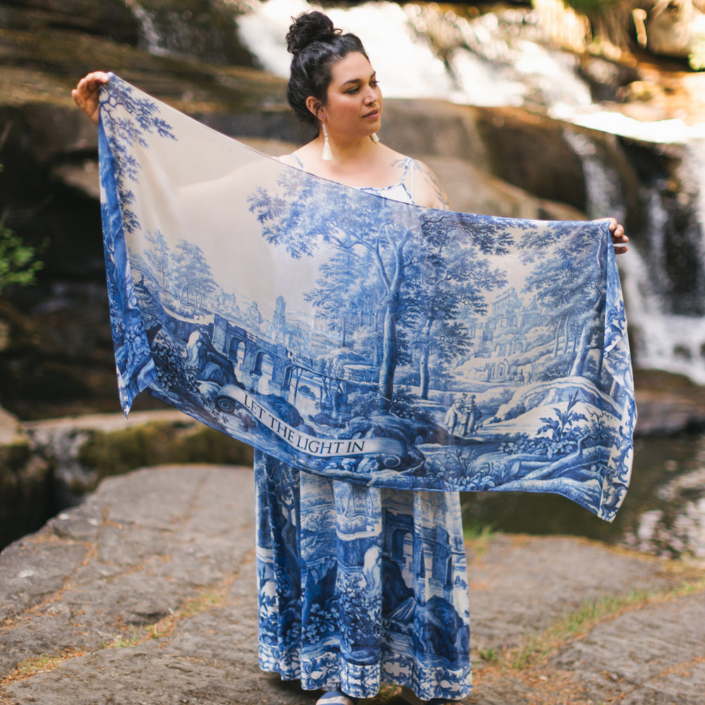 
                  
                    Let the Light In airy bamboo viscose scarf featuring print of Delft blue and white pottery, and positive message of light and hope - Market of Stars
                  
                