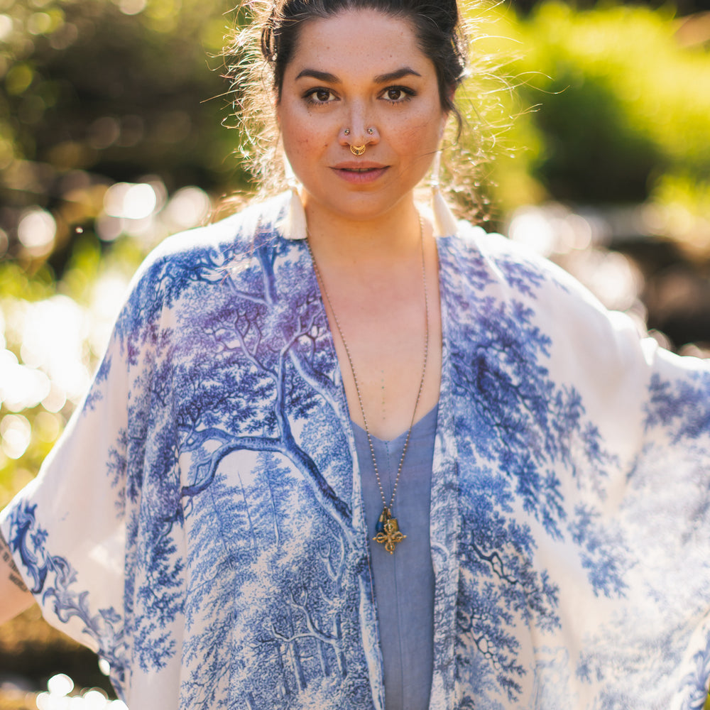 
                  
                    Model wearing Let the Light In Goddess kimono duster featuring print of Delft blue and white landscape pottery, and positive message of light and hope - Market of Stars
                  
                