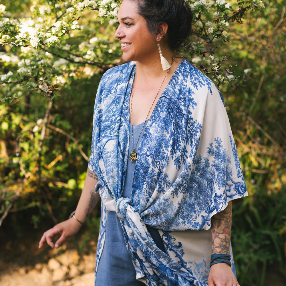
                  
                    Model wearing Let the Light In Goddess kimono duster featuring print of Delft blue and white landscape pottery, and positive message of light and hope - Market of Stars
                  
                