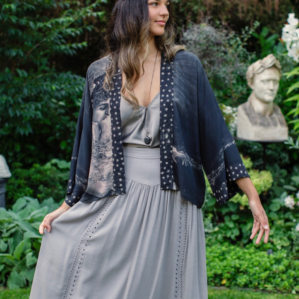 Model wearing Love Conquers All Kimono featuring an 1800s heart-shaped embrace, doves, crescent moon, and the words Amor Vincit Omnia – Market of Stars.