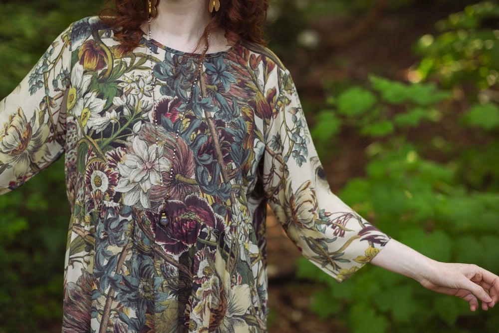 
                  
                    Model styled in Love Grows Wild Artist Dress featuring hand-coloured 1700s floral etchings and bumblebee detail – inspired by the French chemise – Market of Stars
                  
                