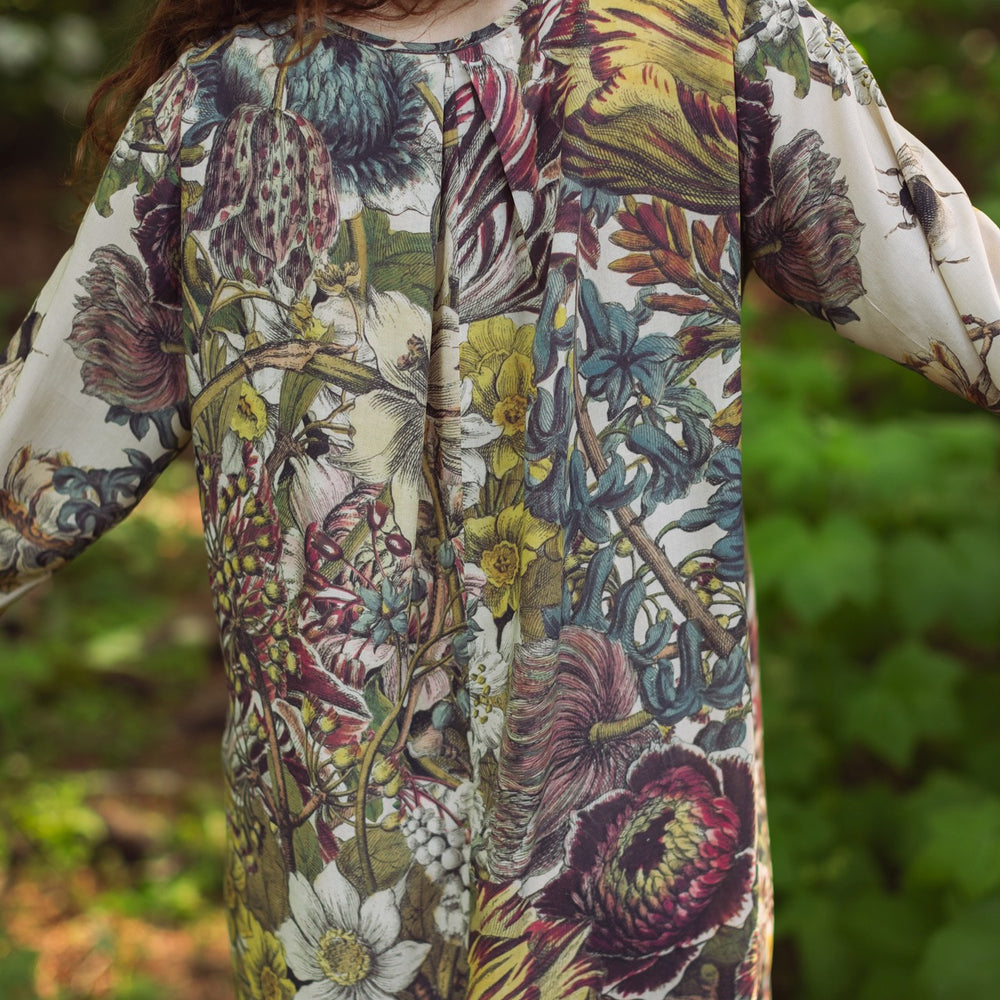 
                  
                    Model styled in Love Grows Wild Artist Dress featuring hand-coloured 1700s floral etchings and bumblebee detail – inspired by the French chemise – Market of Stars
                  
                