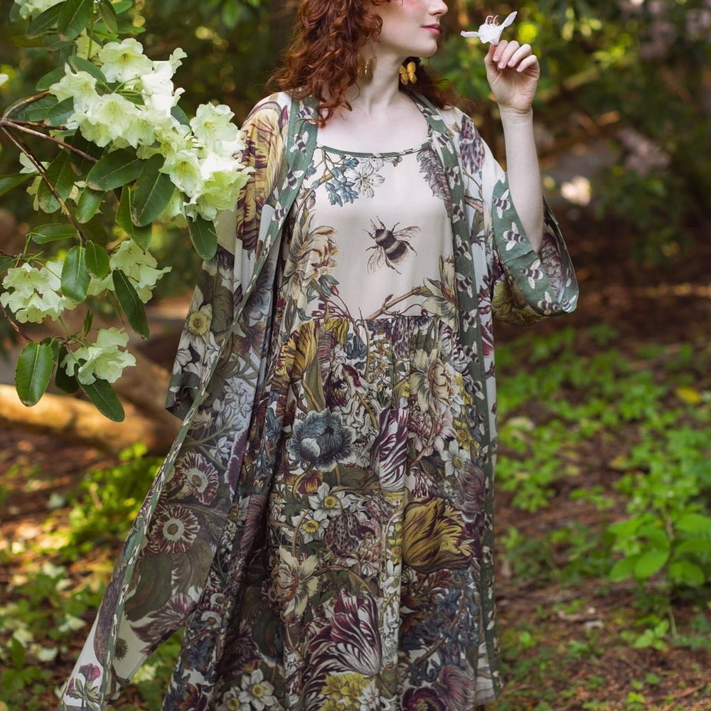 
                  
                    Model wearing Love Grows Wild Bohéme Slip Dress featuring hand-coloured 1700s botanical etchings and bumblebee detail – adjustable, flowy, and reversible – Market of Stars.
                  
                