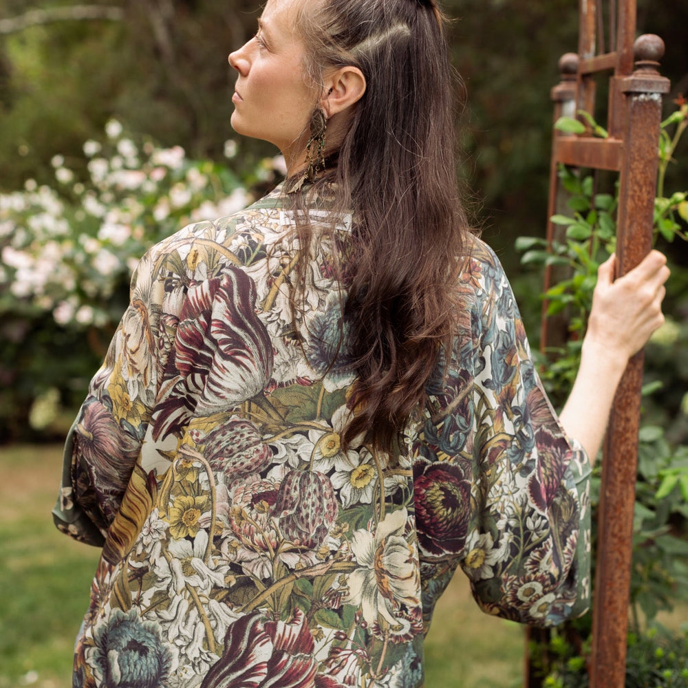 
                  
                    Model wearing Love Grows Wild Pixie Duster featuring hand-coloured 1700s floral etchings and charming bumblebee trim, celebrating the joy of abundance – Market of Stars.
                  
                