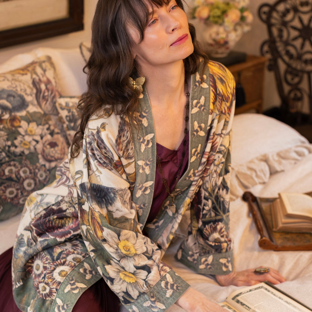 
                  
                    Model wearing a soft cotton velvet duster featuring lush 1700s botanical blooms and bumblebee trim - Market of Stars
                  
                