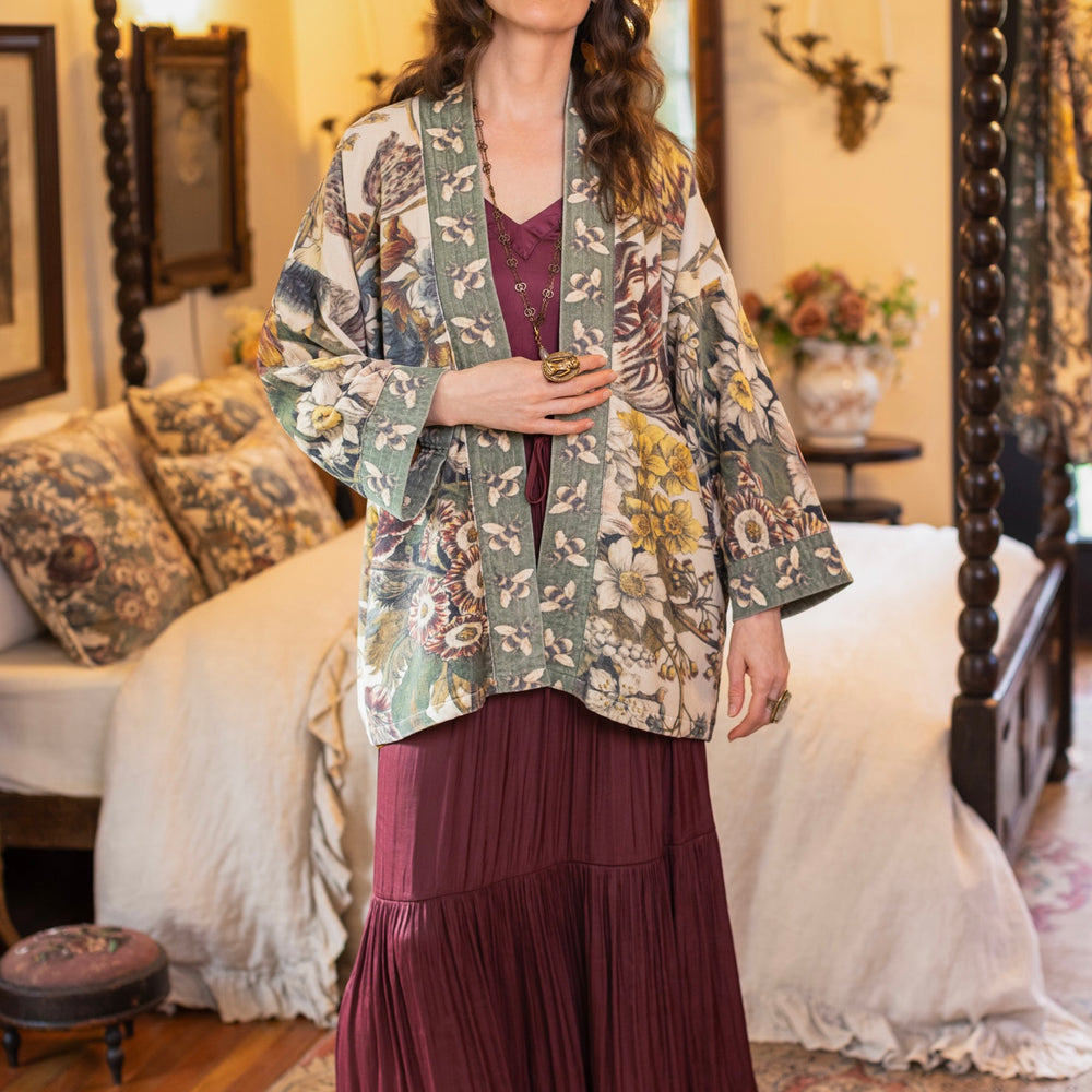 
                  
                    Model wearing a soft cotton velvet duster featuring lush 1700s botanical blooms and bumblebee trim - Market of Stars
                  
                