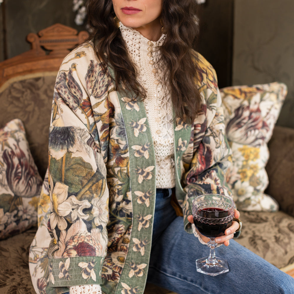 
                  
                    Model wearing a soft cotton velvet duster featuring lush 1700s botanical blooms and bumblebee trim - Market of Stars
                  
                