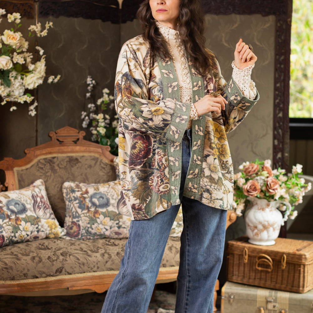 
                  
                    Model wearing a soft cotton velvet duster featuring lush 1700s botanical blooms and bumblebee trim - Market of Stars
                  
                