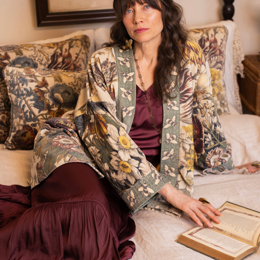 
                  
                    Model wearing a soft cotton velvet duster featuring lush 1700s botanical blooms and bumblebee trim - Market of Stars
                  
                