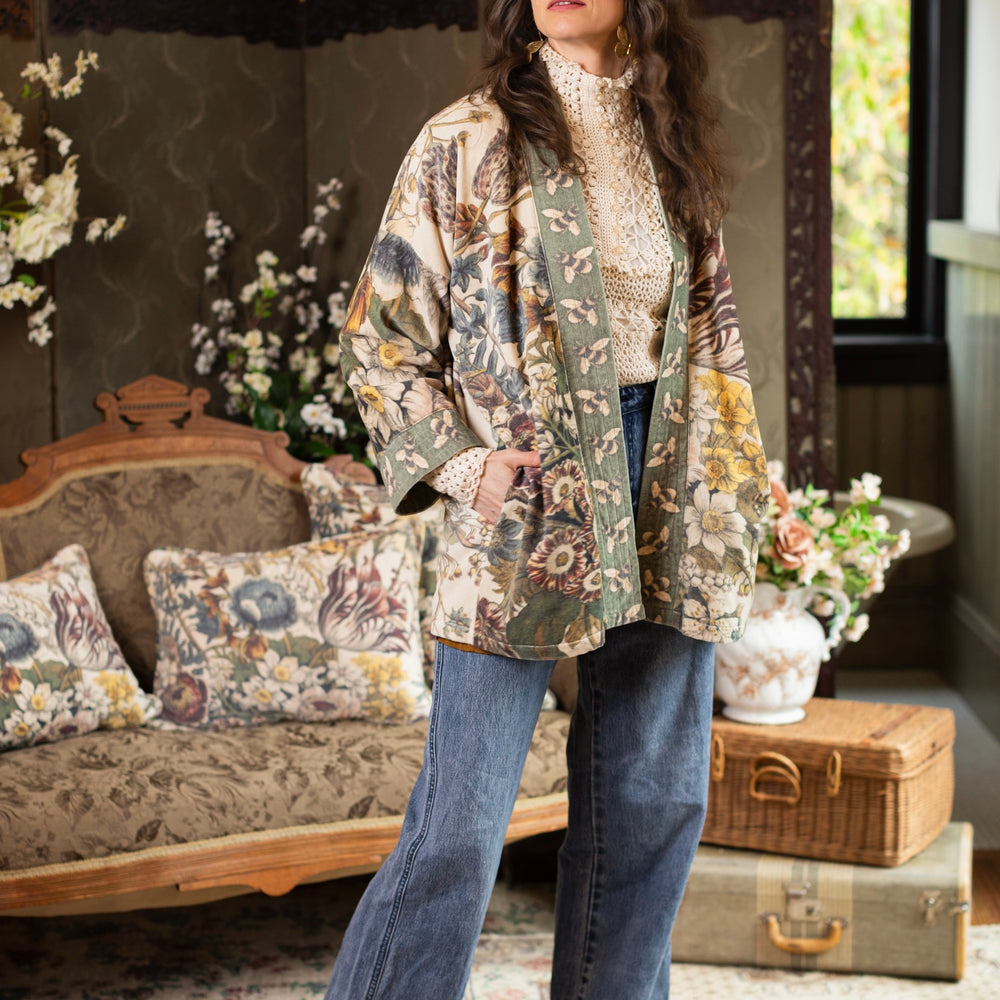 
                  
                    Model wearing a soft cotton velvet duster featuring lush 1700s botanical blooms and bumblebee trim - Market of Stars
                  
                