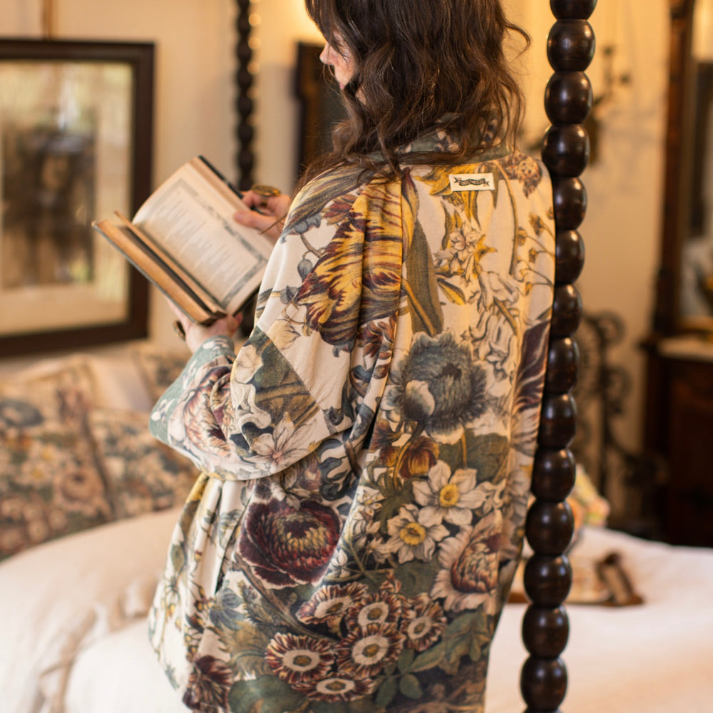 
                  
                    Model wearing a soft cotton velvet duster featuring lush 1700s botanical blooms and bumblebee trim - Market of Stars
                  
                