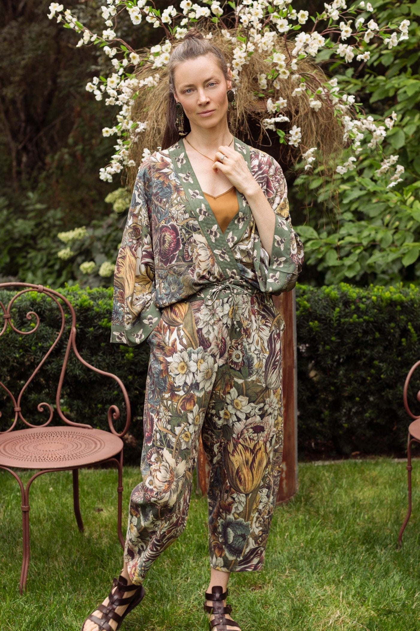 Model styled in Love Grows Wild Artist Pants featuring 1700s hand-coloured floral etchings and bumblebee trim – relaxed lantern hem and cropped fit – Market of Stars
