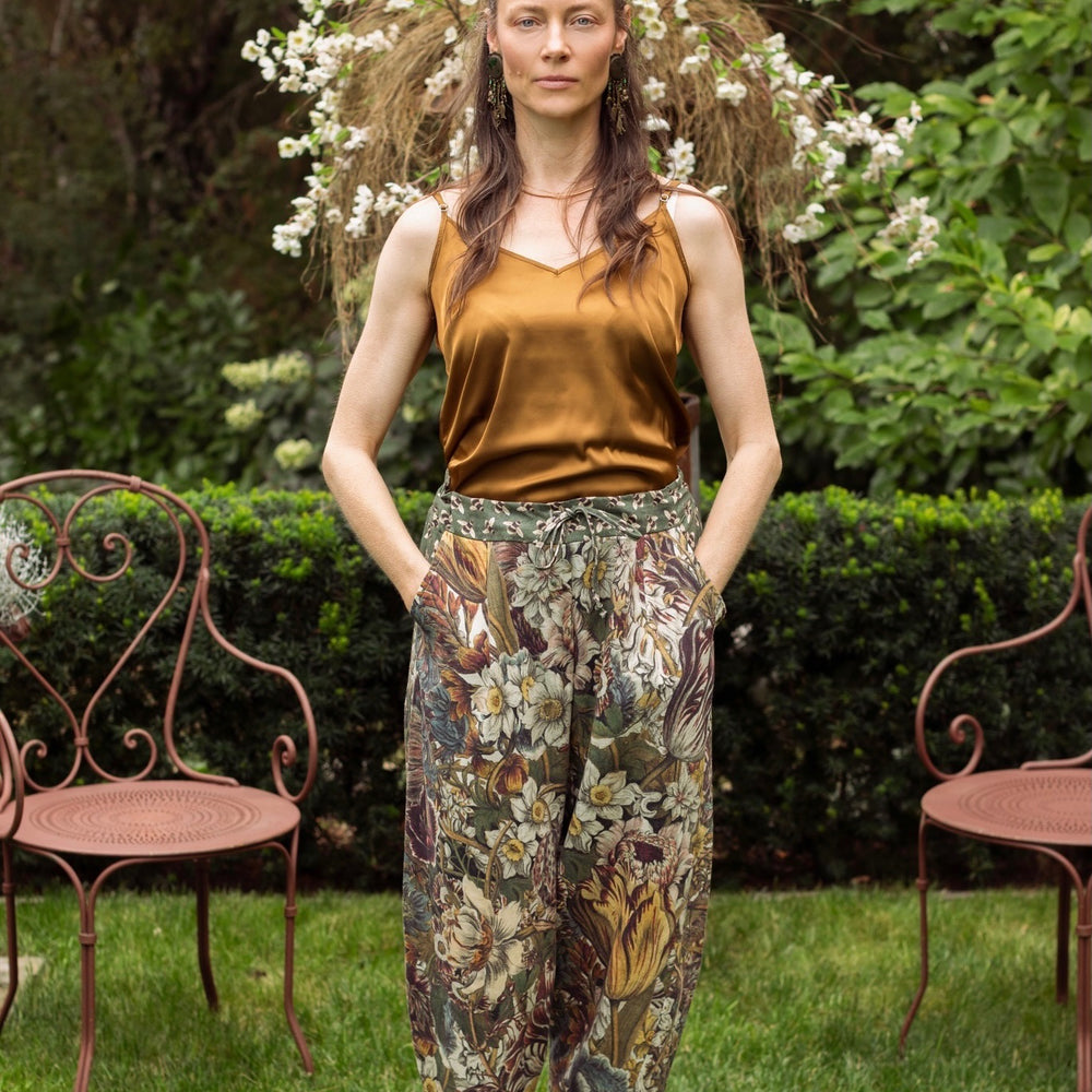 Model styled in Love Grows Wild Artist Pants featuring 1700s hand-coloured floral etchings and bumblebee trim – relaxed lantern hem and cropped fit – Market of Stars