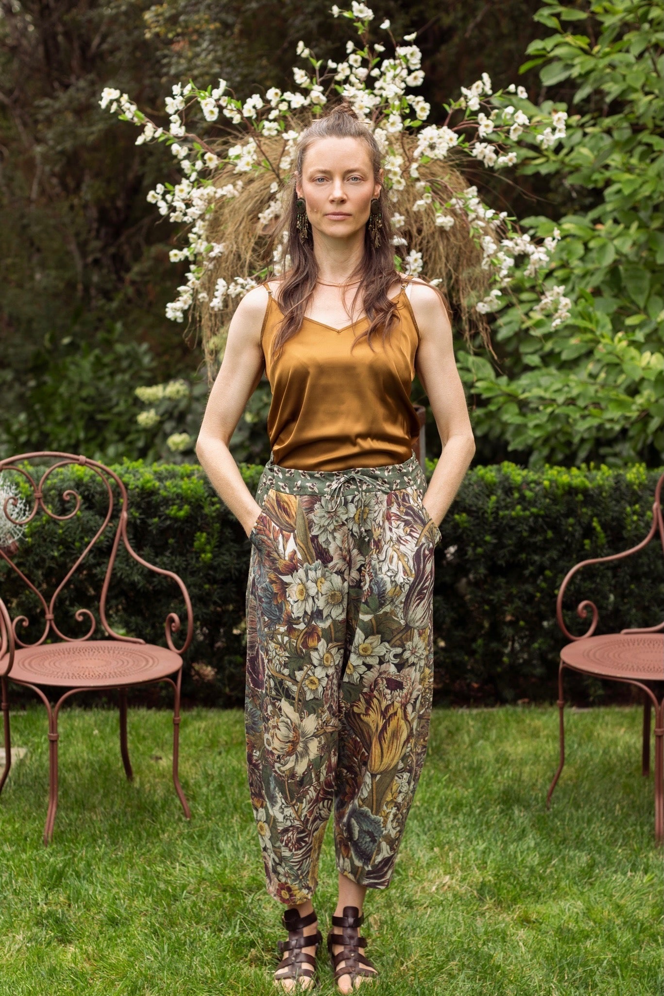 Model styled in Love Grows Wild Artist Pants featuring 1700s hand-coloured floral etchings and bumblebee trim – relaxed lantern hem and cropped fit – Market of Stars