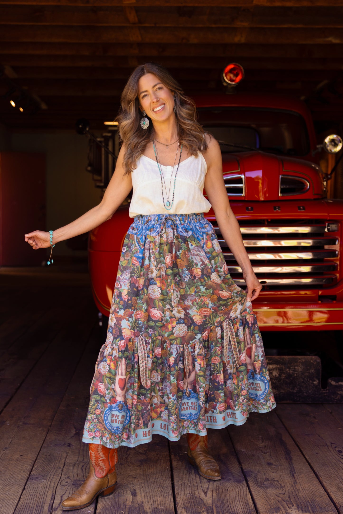 Model wearing a maxi-length skirt woven with 1854 artwork, heartfelt messages, and joyful blooms. Made from bamboo & wood blend viscose - Market of Stars