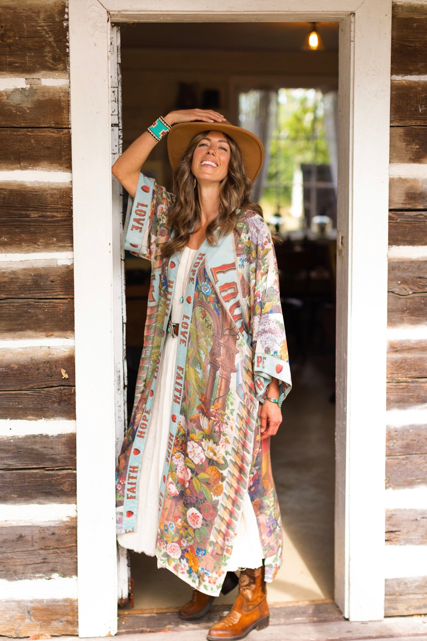 Model wearing romantic full-length kimono featuring joyful 1854 floral art, heart-in-hand symbol, and handwritten messages of love – Market of Stars