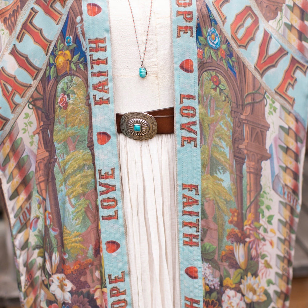 
                  
                    Model wearing romantic full-length kimono featuring joyful 1854 floral art, heart-in-hand symbol, and handwritten messages of love – Market of Stars
                  
                
