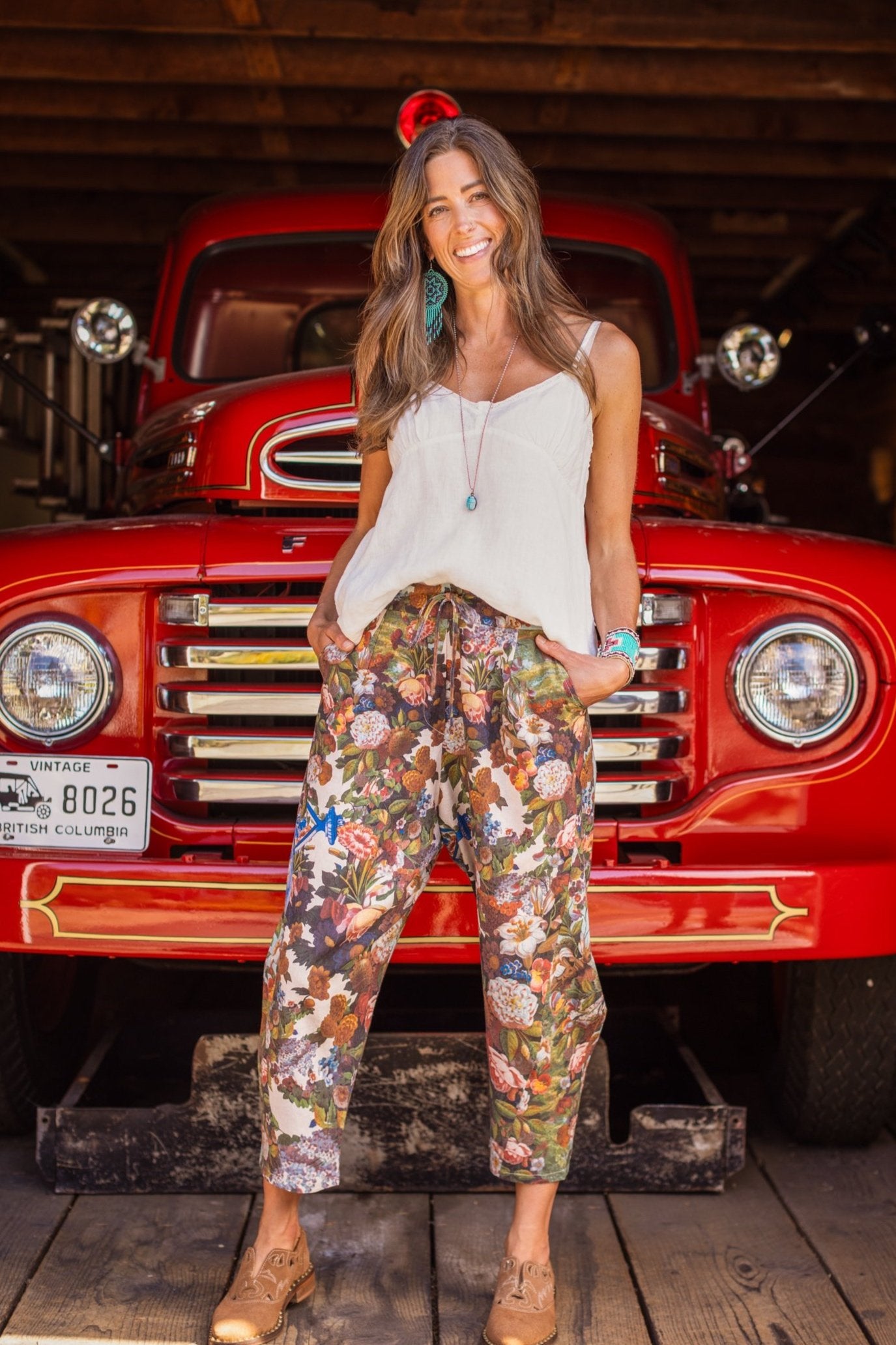 Model wearing linen blend artist pants with 1854 floral art, heart-in-hand symbol, and “Love one another” handwritten script – Market of Stars.