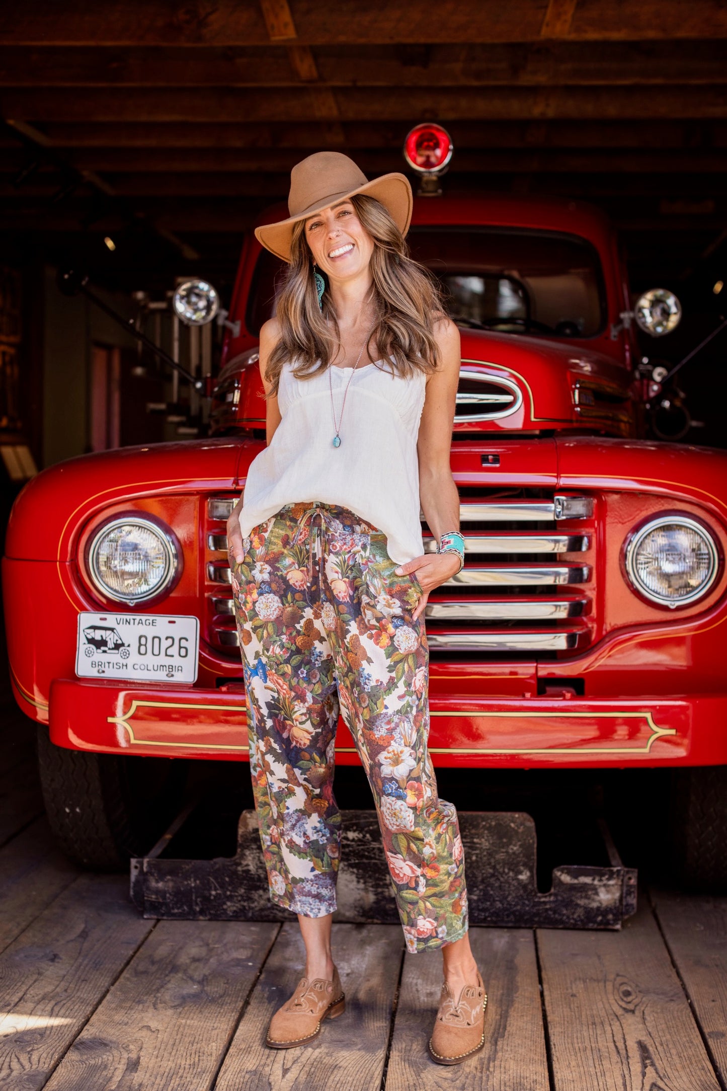 Model wearing linen blend artist pants with 1854 floral art, heart-in-hand symbol, and “Love one another” handwritten script – Market of Stars.