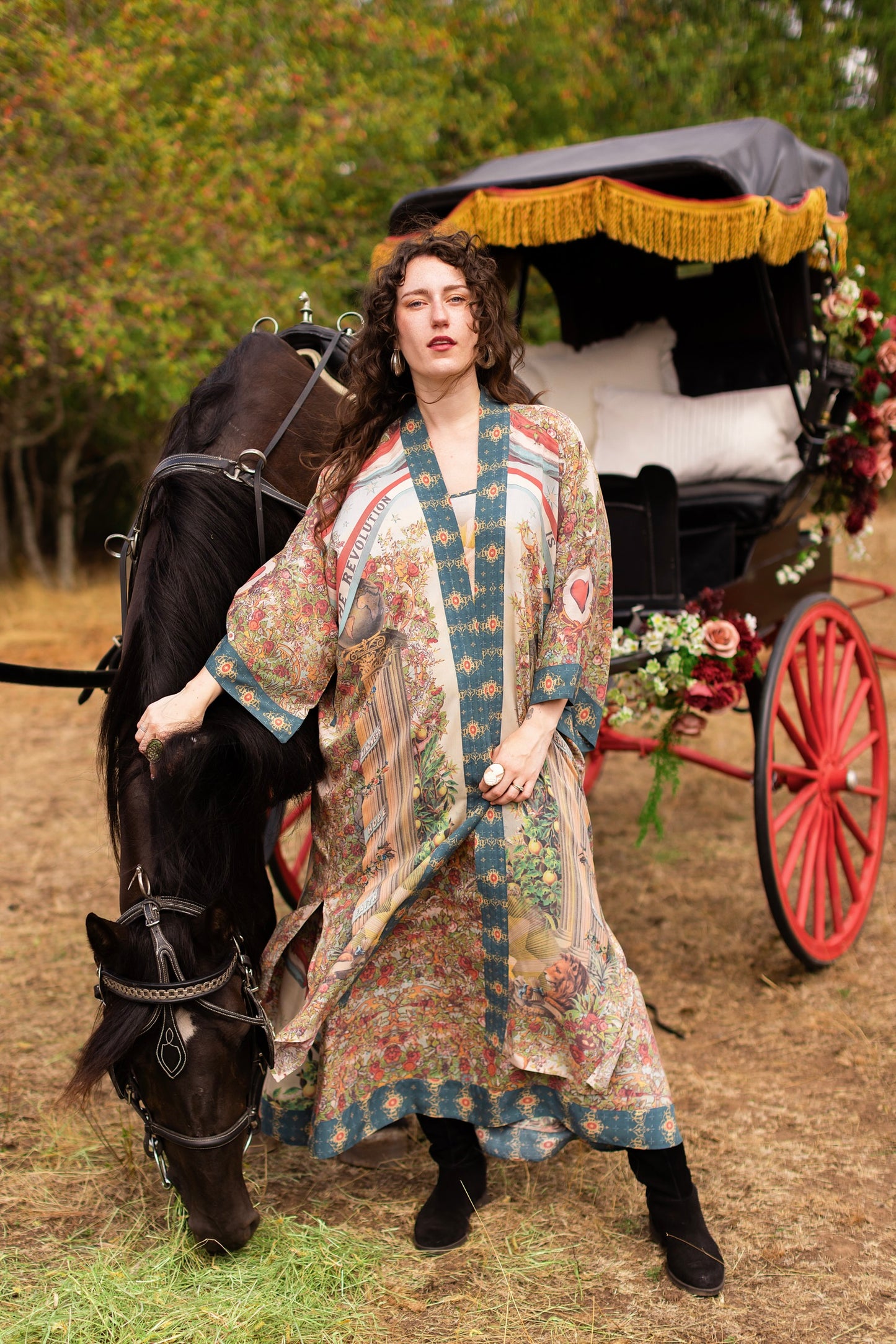 Model wearing a full-length duster ft. a woman astride a rearing horse, soft vintage florals, rosettes and lithographs from the 1800's - Market of Stars